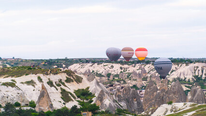 Cappadocia. Hot air balloons flying over Cappadocia in a dramatic sky. Travel to Turkey. Selective...