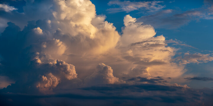 Beautiful thunder storm clouds lit by sunset