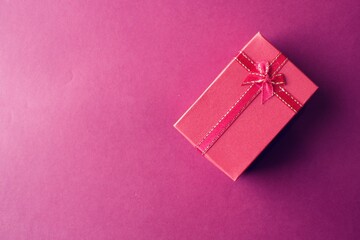 Valentine present. Red gift box and ribbon for romantic couple.