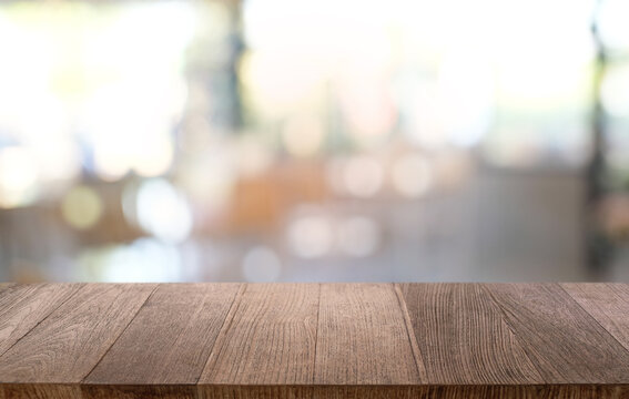 Empty wood table top and blur of night market background/selective focus .For montage product display.