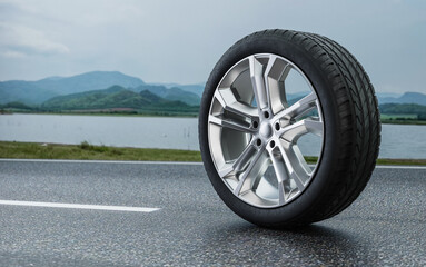 Car alloy wheels placed on a beautiful natural road.