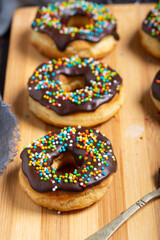 Homemade donuts on a wooden board on a grunge table. Close up - 611685789