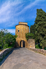 The colorful medieval houses and alleys of San Quirico d'Orcia in a sunny spring day