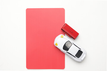 Flatlay picture of car diorama with tool box and copyspace red card . Car liabilities concept.