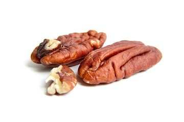 Peeled pecan nuts isolated on a white background. Heap of pecan halves