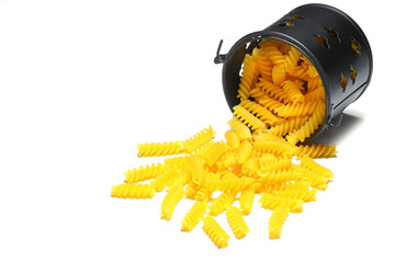 pile of spiral pasta scattered on light background. corkscrew shaped spiral pasta or fusilli pasta...