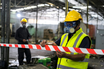 2 officers wearing gas masks, stretching ropes to limit disaster zones, dangerous zones in chemical spill areas in industrial warehouses for damage assessment, inspecting and evaluating toxic spills.