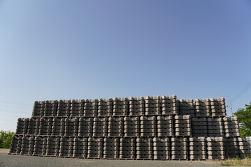 a collection of cement blocks or bricks lined up outdoors