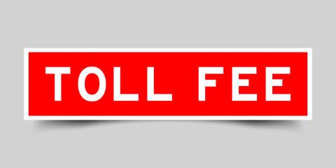 Red color square shape sticker label with word toll fee on gray background