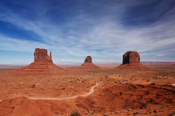Amazing red rock formations in the Monument Valley, Navajo Tribal Park, Utah, USA. Dry landscape and dramatic clouds.