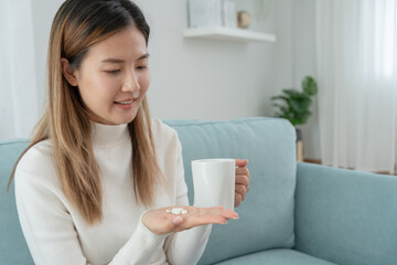 girl holding medicine and take medicine, pain, cure disease, sterilize, take vitamin, sedative, health care, Dietary supplement, medicine for medical treatment, tonic, daily dosage of medication.