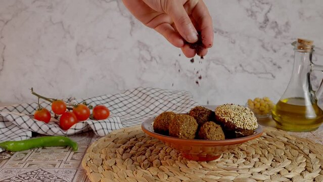 sprinkling sumac on falafel as garnish - slow motion 1080p120 - High quality colors