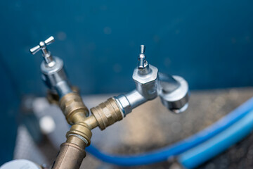 water tap connection with pipes in selective focus