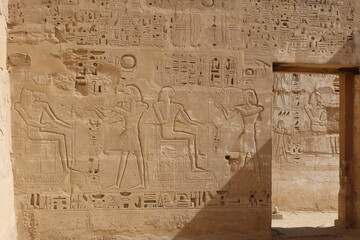 Inscriptions on the walls of the mortuary temple of Medinet Habu in Luxor in Egypt