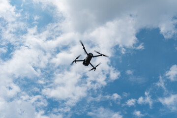Fototapeta na wymiar Drone flying in cloudy sky
