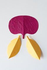 organic magenta pink shape with two leaves made of yellow paper