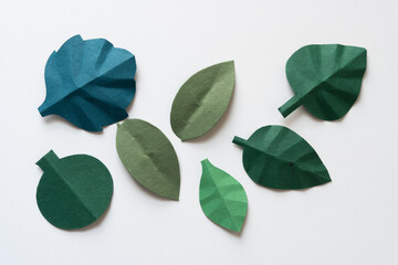 collection of cut paper leaves with some folds
