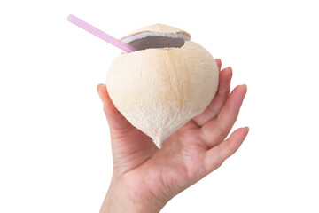 A woman's hand holds a young coconut with the top open, juice and straw