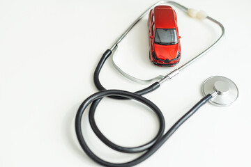 Stethoscope checking up the car on white background, Concept of car check up, repair and maintenance. 
