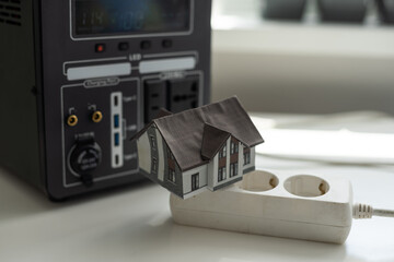 Obraz premium Portable power station charging devices on floor in living room Home