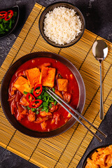 Korean traditional food, spicy kimchi soup (kimchi tige) with pork and tofu cheese.