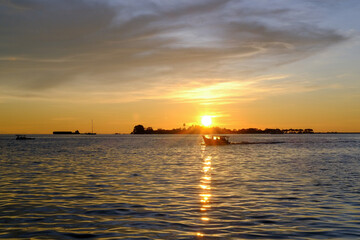 sunset view from the pier in makassar city, sunset at the sea, sunset over the sea, sunset in the sea