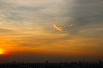 orange blue sky background with cloud and town building in evening of the day sunset