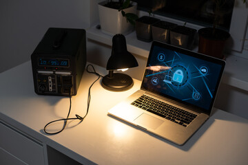 Portable power station charging gadgets on table in room.