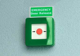 A button behind the glass to break outside the building on the wall in case of failure and fire which emergency door release