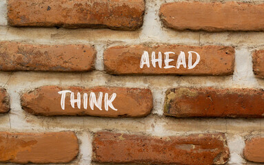 Think ahead symbol. Concept words Think ahead on beautiful brown brick wall on a beautiful brown brick wall background. Business, support, motivation, psychological and think ahead concept. Copy space