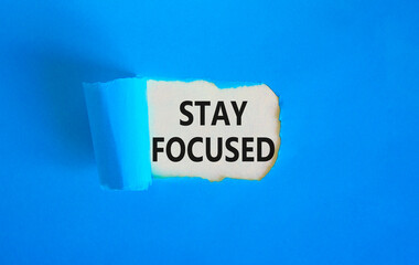 Stay focused symbol. Concept words Stay focused on beautiful white paper on a beautiful blue background. Business, support, motivation, psychological and stay focused concept. Copy space.