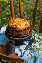 Homemade cake on a chair in a garden of blooming dandelions. Close up - 611737961