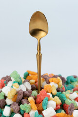 Gold color spoon come from colorful cornflakes