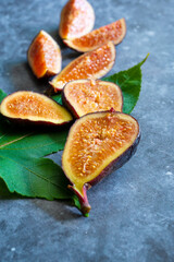 figs with green leaves, selective focus. Fresh purple fig fruit