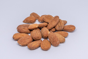 Beautiful almonds are seen harvested on a white background and ready to be consumed.
