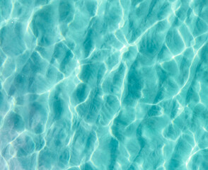 Ocean scene seen from above with stunning blue lines and light reflecting through the ocean floor