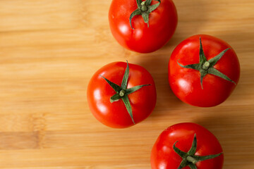 tomatoes back ground healthy food over a wood plate