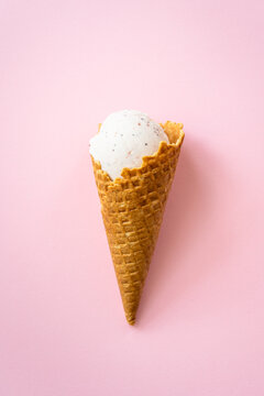 Ice cream cone top view on pink. Minimal composition.