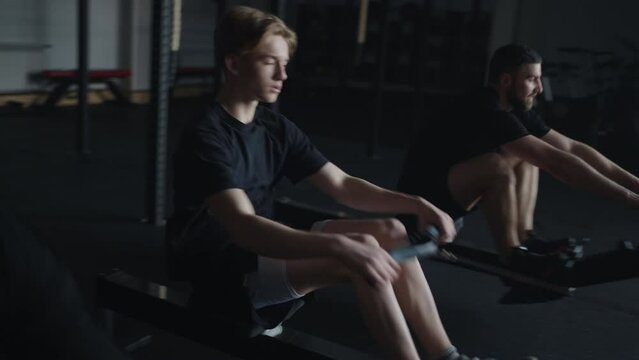 Teen Boy And Young Men Training In Gym, Exercise Machine For Muscles Of Arms And Abs