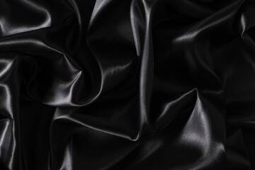 Silk fabric, abstract wavy black satin fabric background.