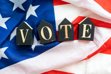 Top view of wooden cubes with letters 2024 over the American flag background. United States...
