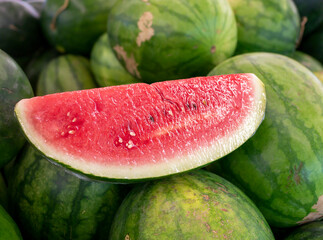 Fresh red watermelons on shelves in  supermarket