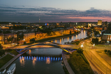 Fototapeta na wymiar Scenic aerial view of Vilnius Old Town and Neris river. Sunset landscape. Night view of Vilnius, Lithuania.