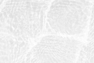 White water with ripples on the surface. Defocus blurred transparent white colored clear calm water surface texture with splashes and bubbles. Water waves with shining pattern texture background.