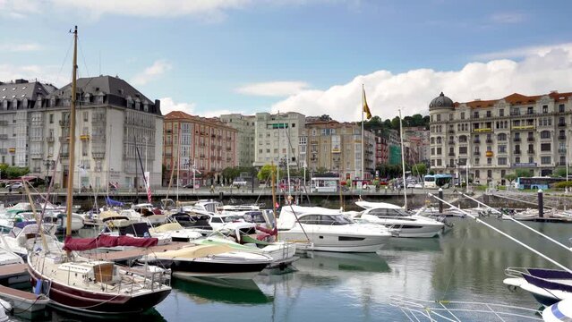 Santander, SPAIN - August 21 2022: Beautiful port of Santander. Boats docked. Travel destination in North of Spain. Panoramic view of marina and part of the city center. Stabilized static video