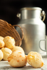 Cheese bread, Basket with cheese bread lying on a white lace tablecloth and accessories, dark background, selective focus.