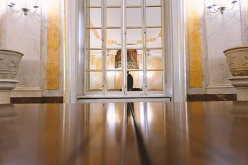 Polished table overlooking a vintage window.