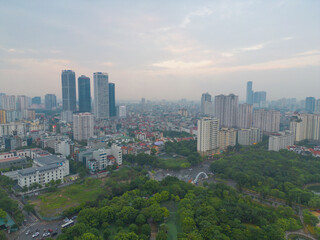 Fototapeta premium Aerial view of Hanoi Downtown Skyline with green garden park, Vietnam. Financial district and business centers in smart urban city in Asia. Skyscraper and high-rise buildings.