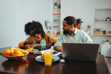 Fototapeta na wymiar A multiracial family at the breakfast table at home in the morning.