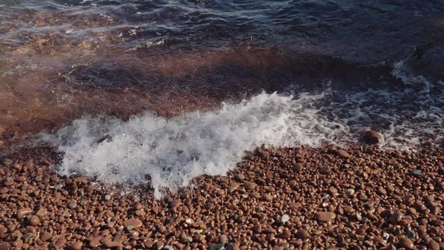 Slow motion closeup shot of clear sea water on Saint Raphael beach